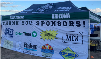 STMS team tent with sponsor logos displayed across the front banner